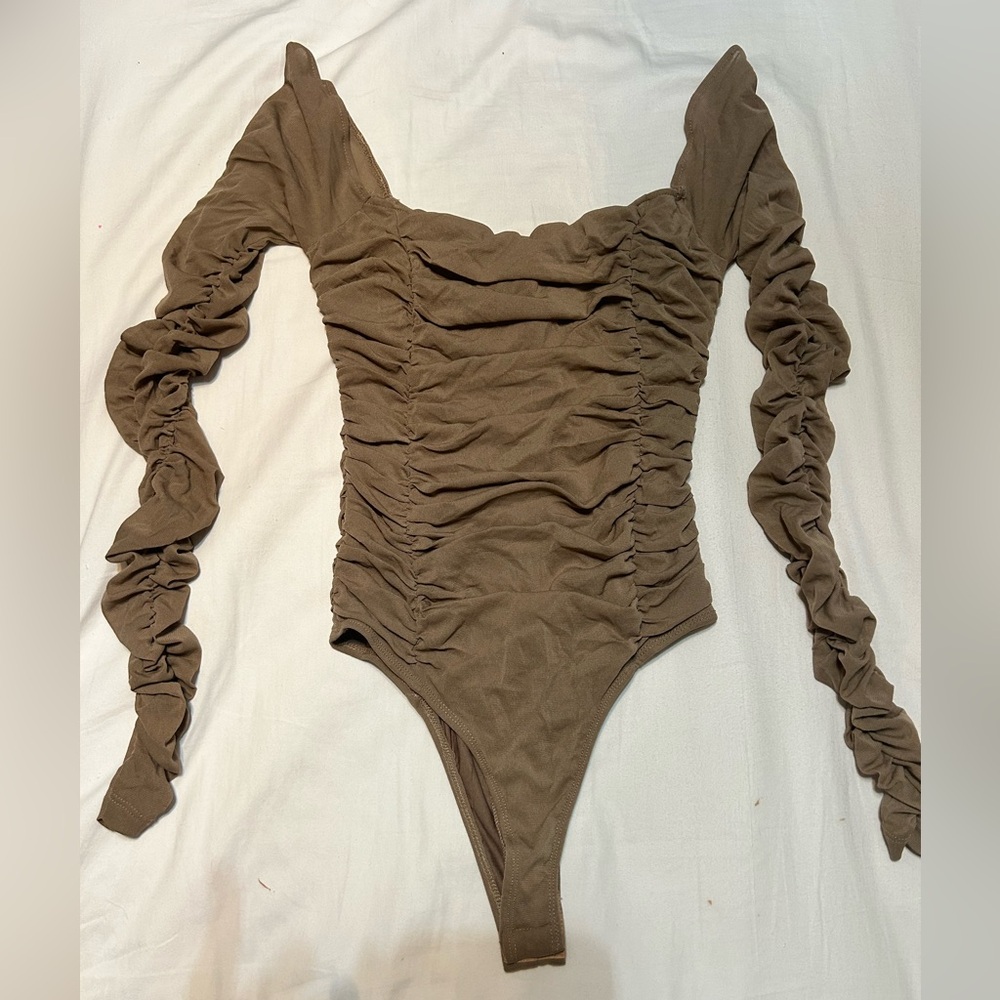 Bodysuit. Tan. Sheer ruffles in the arm.
